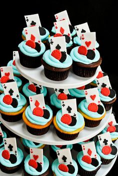 cupcakes with blue frosting and cards on them