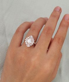 a woman's hand with a diamond ring on it