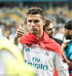 a soccer player giving the thumbs up sign