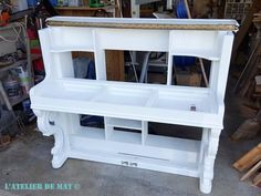 a white bench sitting inside of a garage