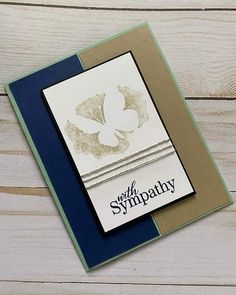 a close up of a greeting card on a wooden surface with the words sympathy written in black and white