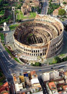 an aerial view of the colossion in rome, italy with traffic and buildings around it