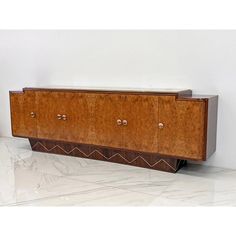 an art deco sideboard with two doors and three knobs on the bottom shelf