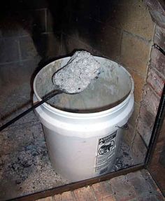 a bucket is sitting on the floor next to a brick wall with a wire sticking out of it