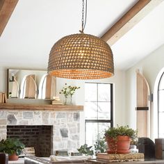 a living room filled with furniture and a fire place under a chandelier hanging from the ceiling