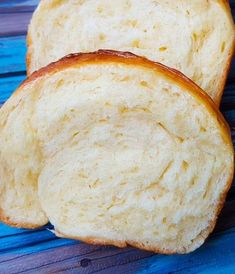 two pieces of white bread sitting on top of a blue table next to each other