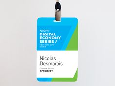 an id card is attached to a white wall with a blue and green tag that says, digital economy series 1 nicholas desamaris