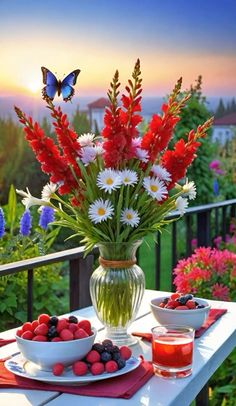 a vase filled with flowers sitting on top of a table next to fruit and berries