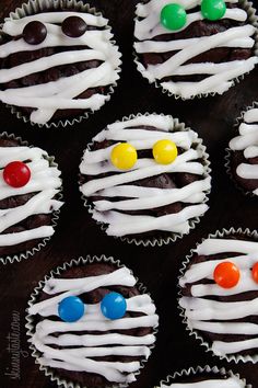 cupcakes decorated with white icing and colorful candies are displayed on the instagram page