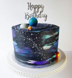 a space themed birthday cake with the words happy birthday written on top and planets painted on it