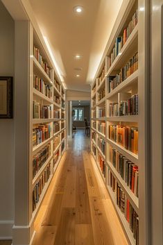 a long narrow room with many books on the shelves