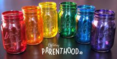 there are many different colored mason jars lined up in the same row and one is labeled parenthood