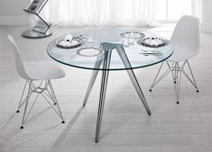 a glass table with four chairs around it