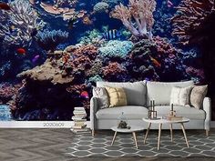 a living room with a large fish tank wall mural on the wall and a couch in front of it