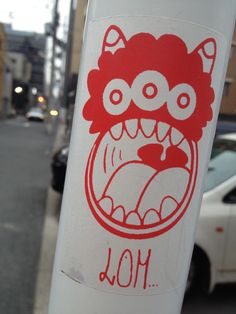 a sticker on the side of a pole with an image of a monster's mouth