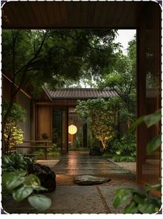 the entrance to a japanese garden with trees and plants around it, at night time