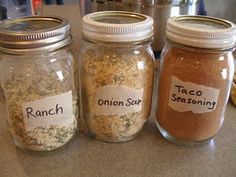 there are two jars with spices on the table next to each other, one containing an onion seasoning mix