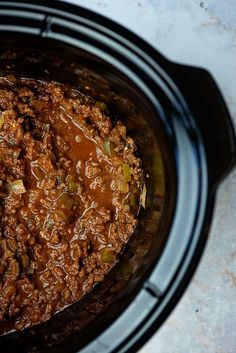 a crock pot filled with ground beef and vegetables