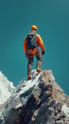 a man standing on top of a snow covered mountain