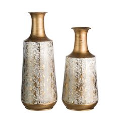 two gold vases sitting next to each other