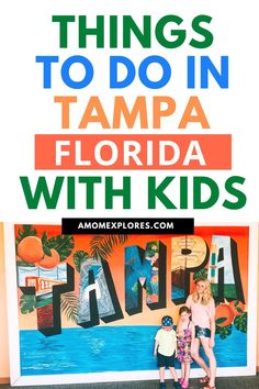 two children standing in front of a sign that says things to do in tampa with kids