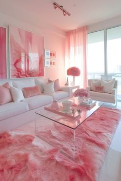 a living room filled with white furniture and pink rugs on the floor in front of large windows