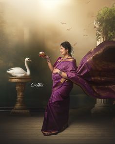 a woman in a purple sari holding a flower and a white swan standing next to her