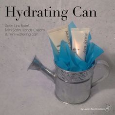 a metal watering can filled with scrubs and hand cream