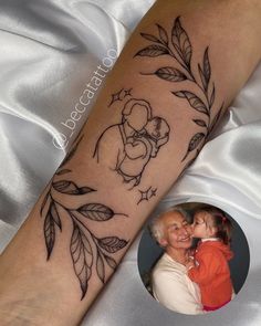 a woman with a tattoo on her arm holding a child