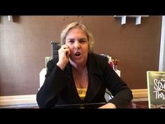 a woman sitting at a table talking on the phone