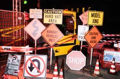 there are many road signs on the construction site