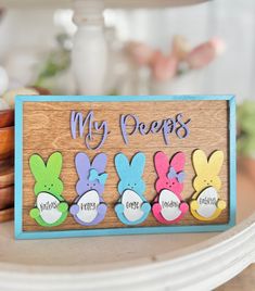 a wooden sign that says, my peeps are painted with colorful easter bunnies