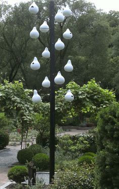 a lamp post in the middle of a garden