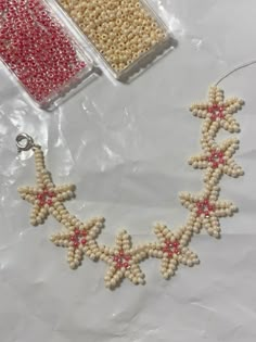 beaded stars and beads are displayed on a table