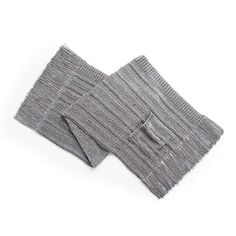 two pieces of gray and white knitted fabric on a white surface, with one piece folded over the other