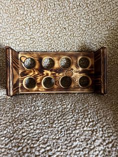 an old wooden board with eight holes in it