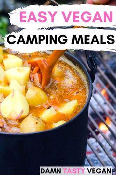 a pot filled with food sitting on top of a grill next to an open fire