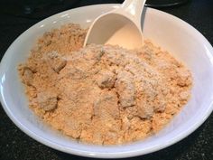 a white bowl filled with food on top of a table