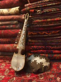 an instrument sitting on top of a pile of rugs