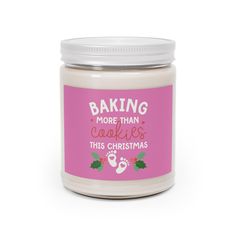 a pink candle with the words baking more than cookies this christmas