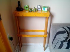 a small wooden table sitting next to a couch