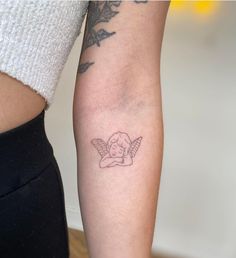 a woman with a small tattoo on her arm