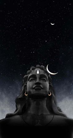 an image of the head of buddha with crescents and stars in the sky