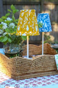 two lamps sitting on top of a wicker tray