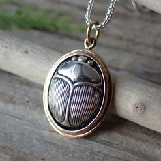 Embark on a journey into the mystique of ancient Egypt with this meticulously crafted pendant, thoughtfully designed to capture the essence of the revered scarab beetle. Expertly fashioned from sterling silver, each piece reflects our commitment to both artistry and enduring quality. Measuring 23mm in length and 14mm in width, this charm encapsulates the intricate details of the scarab beetle, from its distinctive form to its finely etched features. The scarab's symbolism as a representation of Scarab Beetle Jewelry, Beetle Jewelry, Scarab Necklace, Tortoise Beetle, 3d Jewelry, Scarab Beetle, Wax Carving, Old Jewelry, Amulets