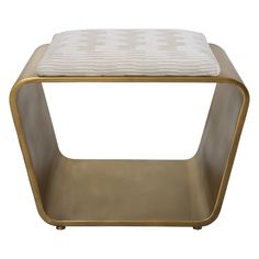 a gold and white stool with a cushion on top