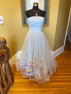 50's style light blue tulle dress. Size 10. Strapless fit and flare. Someone went to a lot of work to add silk faux flowers underneath the tulle. Wonderful for a special event, photoshoot or retro pageant! Interested in more than 1 item from OperaKittyCo?  I do combined shipping, meaning I package your items together and refund the shipping overage! Vintage Tulle Dress For Spring, Vintage Tulle Dresses For Spring, Vintage Fitted Tulle Dress, Fitted Vintage Tulle Dress, Fitted Vintage Tulle Skirt Dress, Vintage Tulle Petticoat For Spring, Vintage Spring Tulle Petticoat, Spring Vintage Tulle Petticoat, Spring Organza Tulle Fabric For Prom