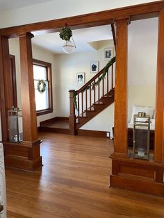 an empty living room with wood floors and wooden banisters in the center area