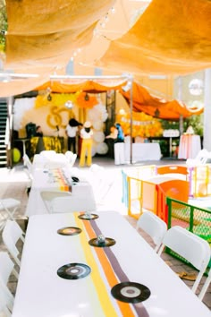 tables and chairs are lined up under an awning