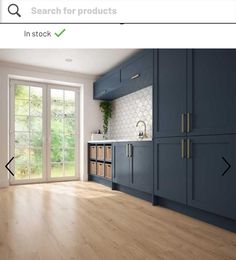 an image of a kitchen with blue cabinets and wood flooring on the phone screen